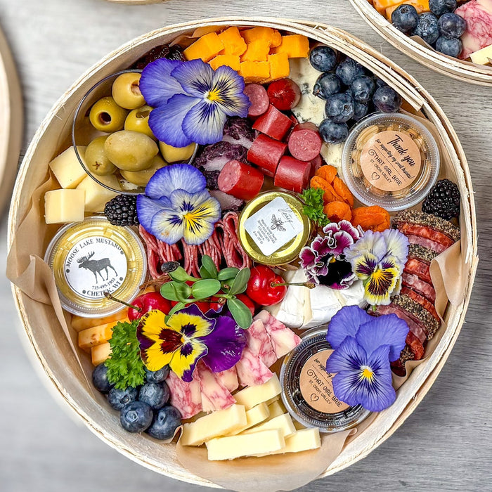 Charcuterie board with jam, honey and mustard cups for pairing