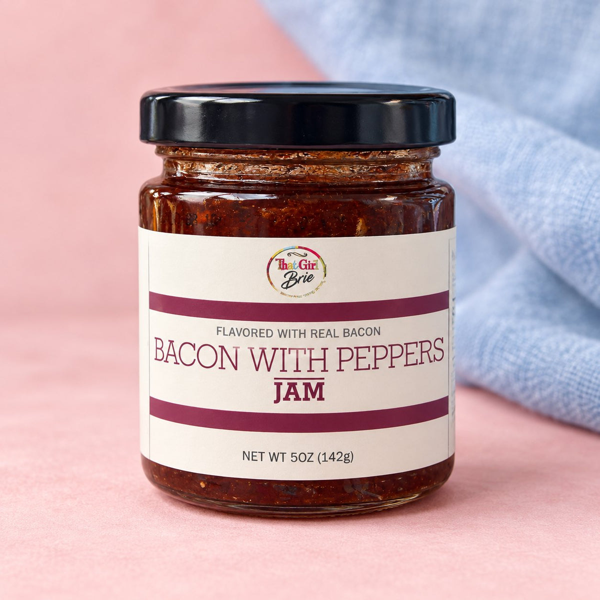 Bacon pepper jam flavored with real bacon, in a small jar with a blue linen napkin