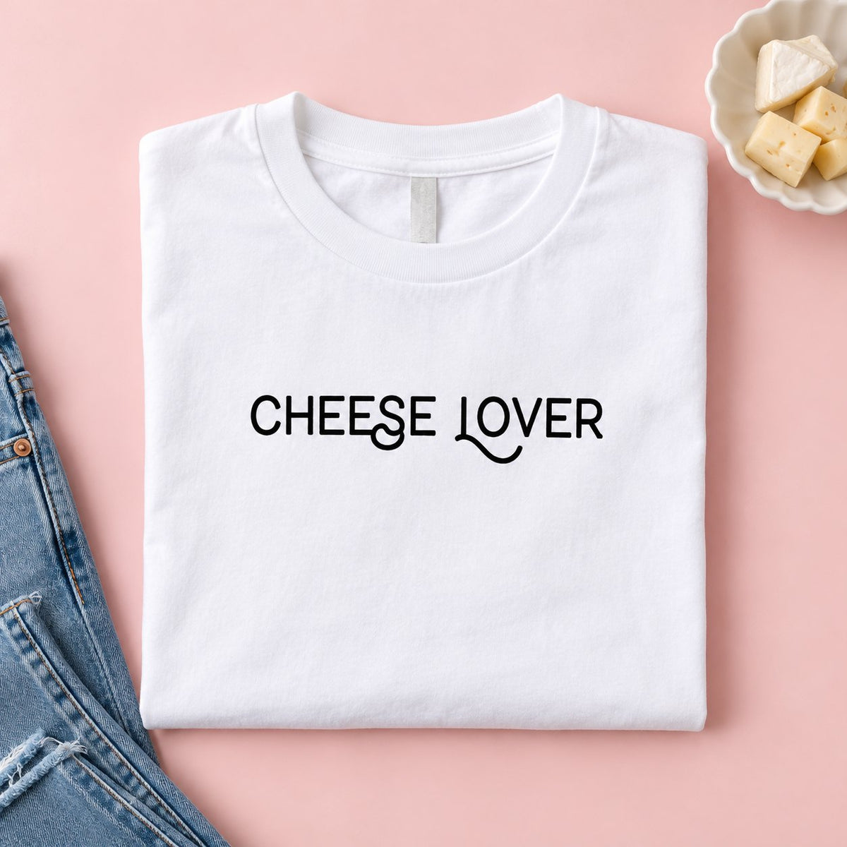 Folded white Cheese Lover t-shirt with cheese and jeans
