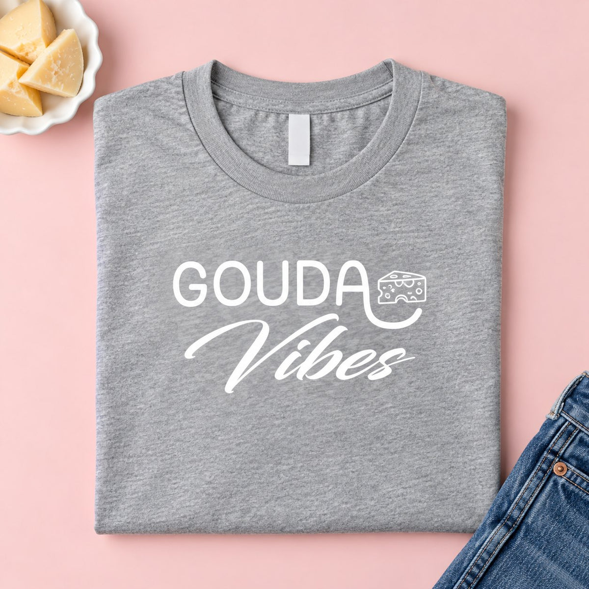 Folded heather grey Gouda Vibes cheese t-shirt with cheese and jeans