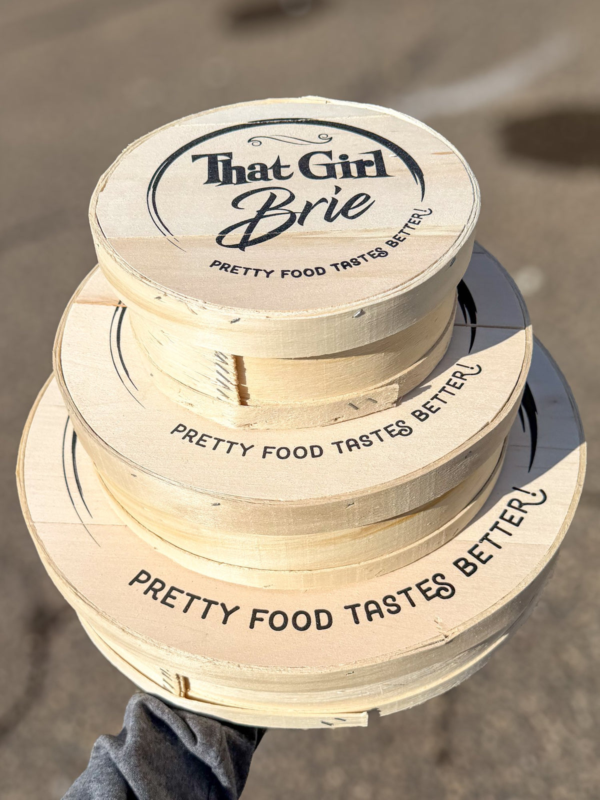 The Keepsake wooden boxes with That Girl Brie lids, stacked in all three sizes