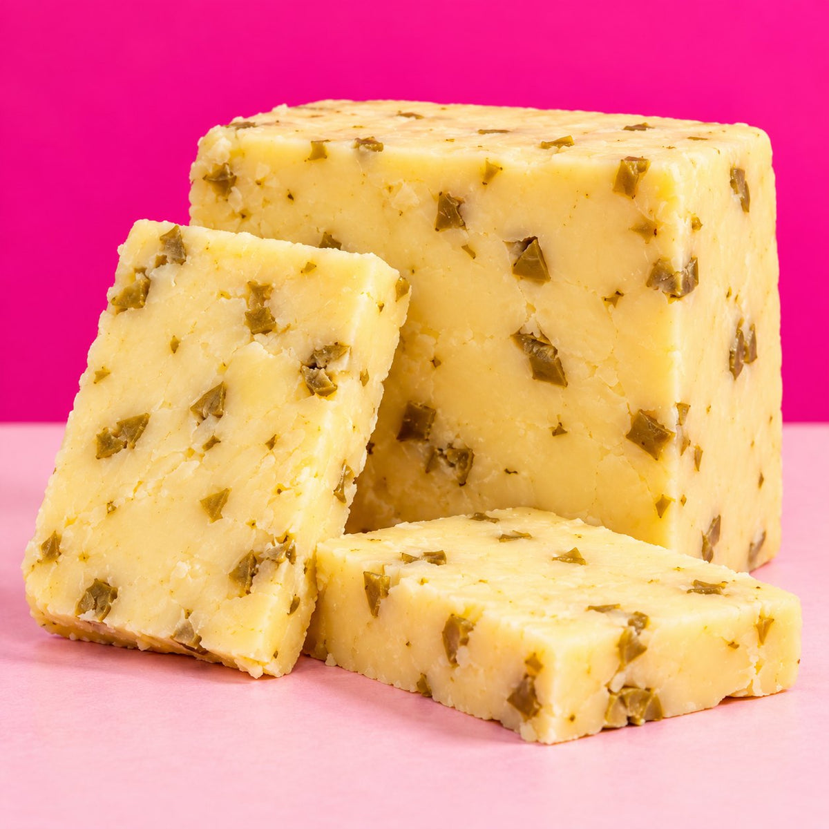 Olive Cheddar cut to show the cheddar with olives inside