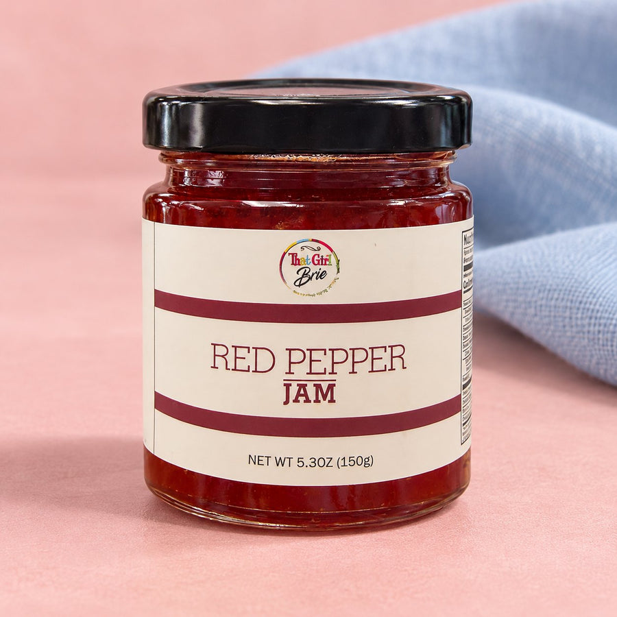 Red pepper jelly in a small jar with a blue linen napkin