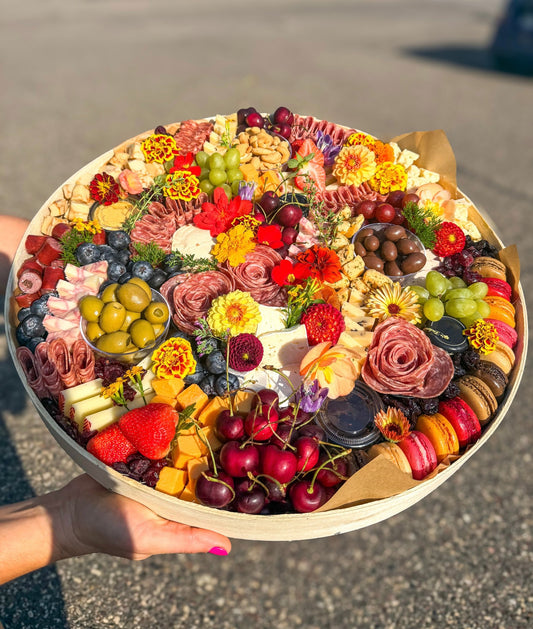 The Shindig Classic, a large charcuterie board for 20 people, with marigolds, salami, cheese cubes and fresh berries