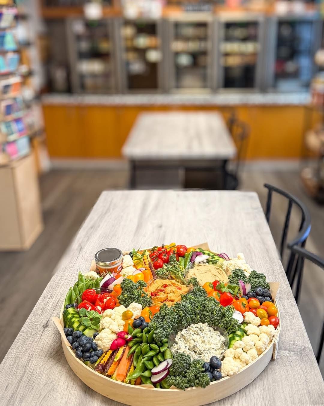 The Garden Shindig, a large veggie grazing board with hummus, dips, broccolini, tomatoes and cauliflower