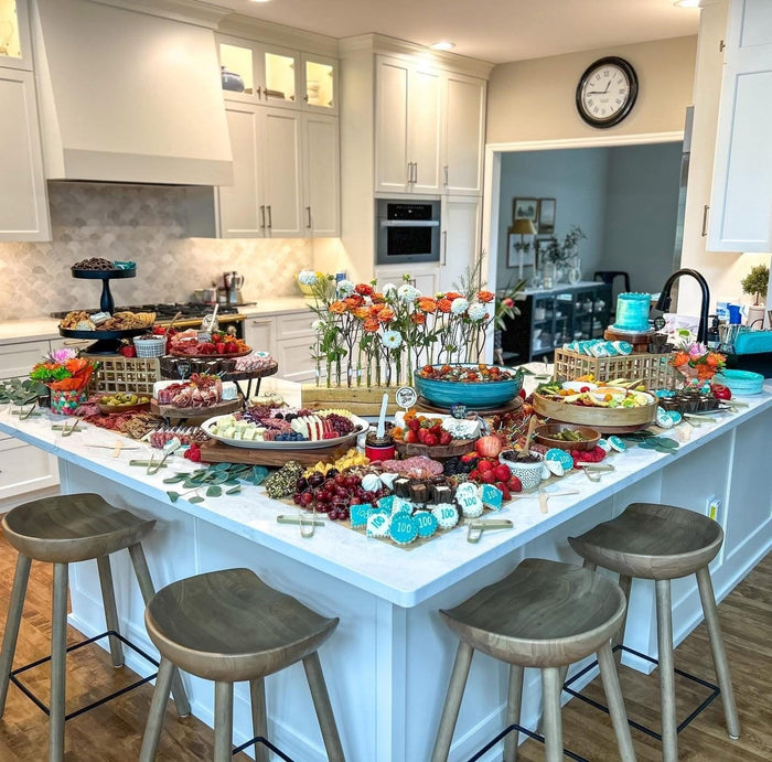 A big That Girl Brie party spread on a kitchen island, made to feed a crowd