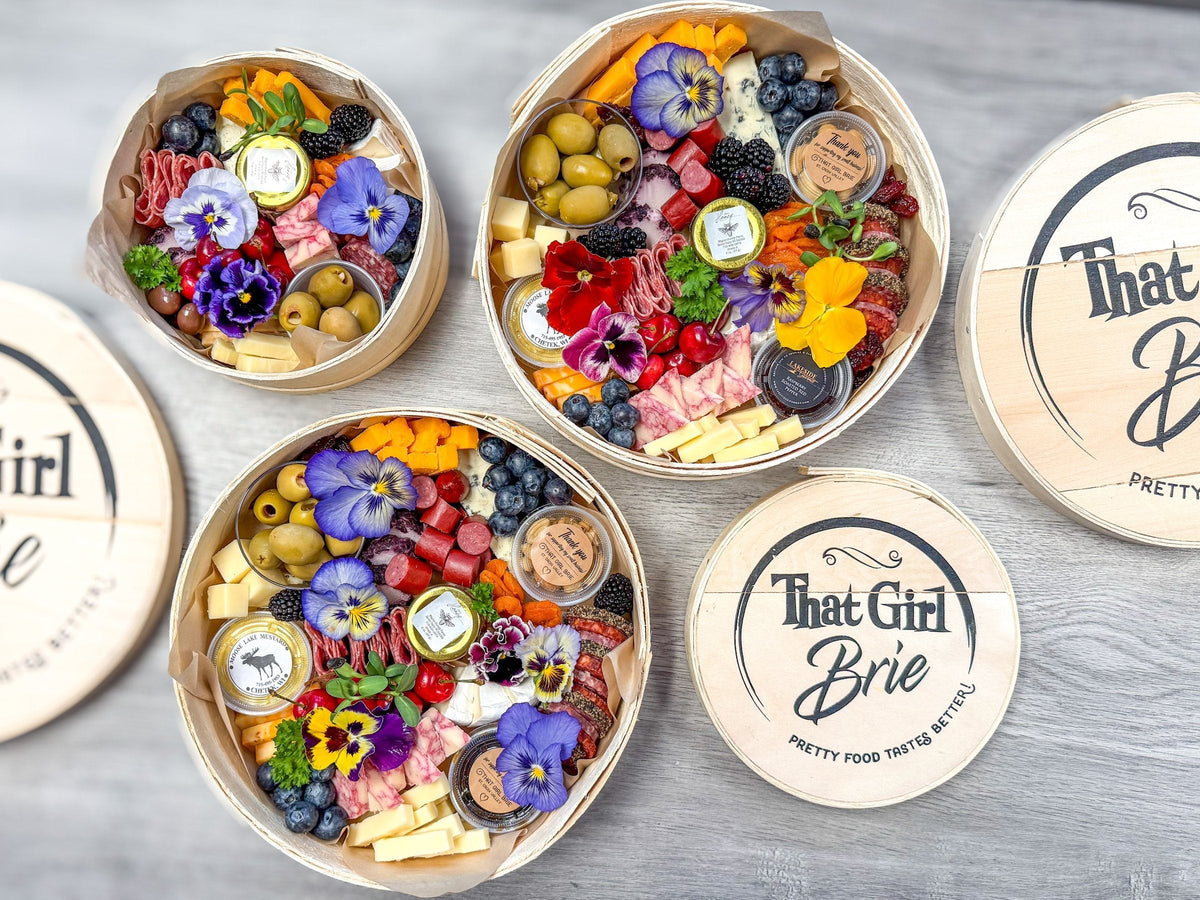What goes on a charcuterie board: cheeses, meats, olives, honey, fruit and flowers in three Keepsake boxes
