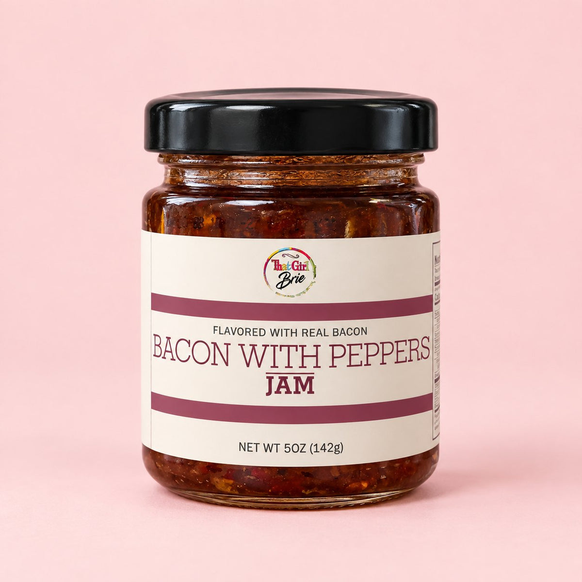 Jar of That Girl Brie Bacon with Peppers bacon pepper jam on a light pink background