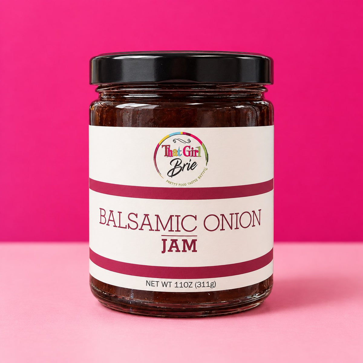 Balsamic Onion jam jar on a hot pink background