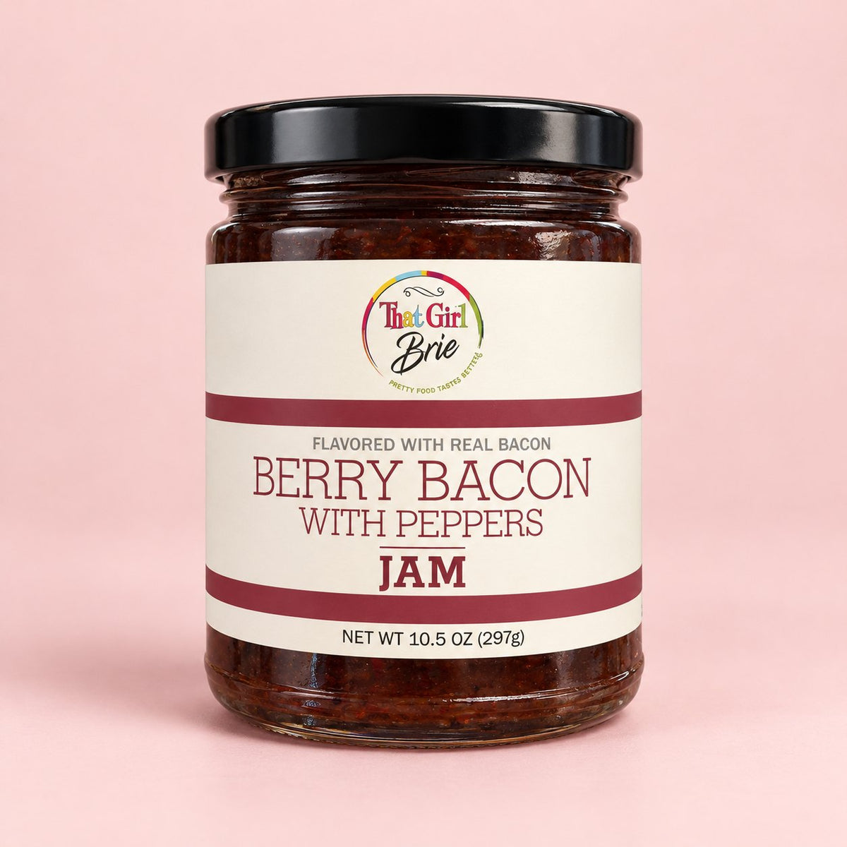 Jar of That Girl Brie Berry Bacon with Peppers bacon berry jam on a light pink background