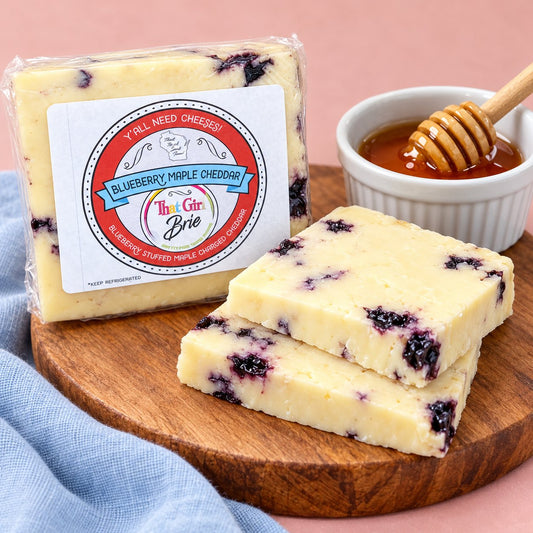 Sliced Blueberry Maple Cheddar blueberry cheddar on a wood board with honey