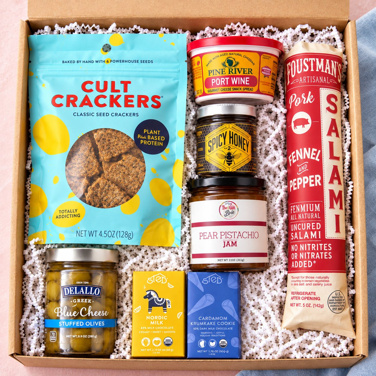 The Board Meeting charcuterie gift box with salami, Cult Crackers, port wine spread, spicy honey, jam, olives and chocolate
