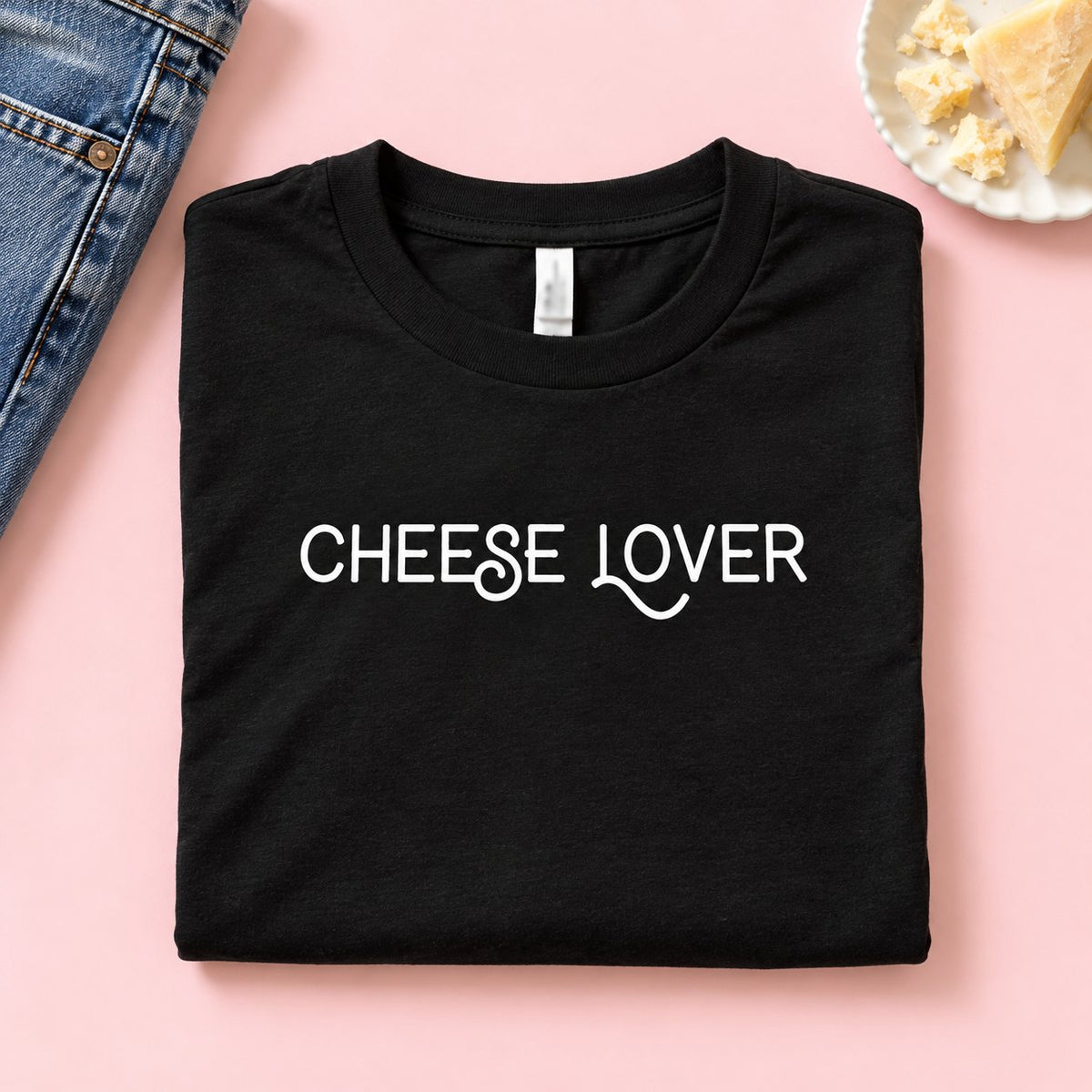 Folded black Cheese Lover t-shirt with cheese and jeans