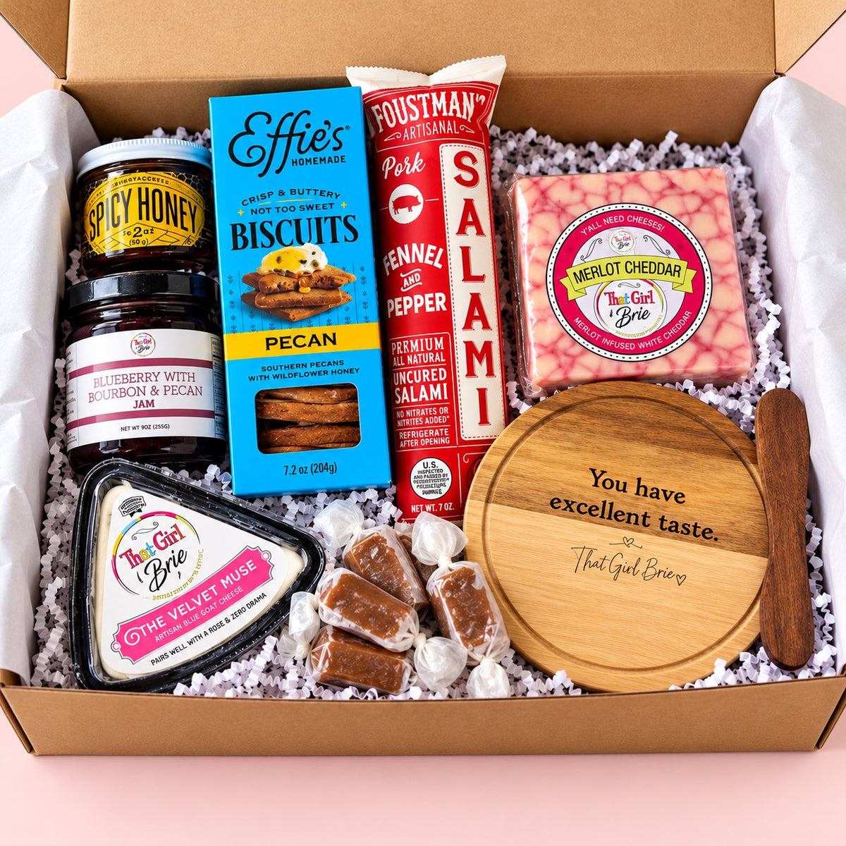 The Excellent Taste Box cheese board gift set with Merlot Cheddar, The Velvet Muse, salami, jam, spicy honey and a mini serving board