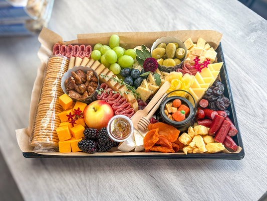 Fall Gather Board charcuterie platter with salami, cheddar, brie, grapes, candied pecans, an apple and candy pumpkins