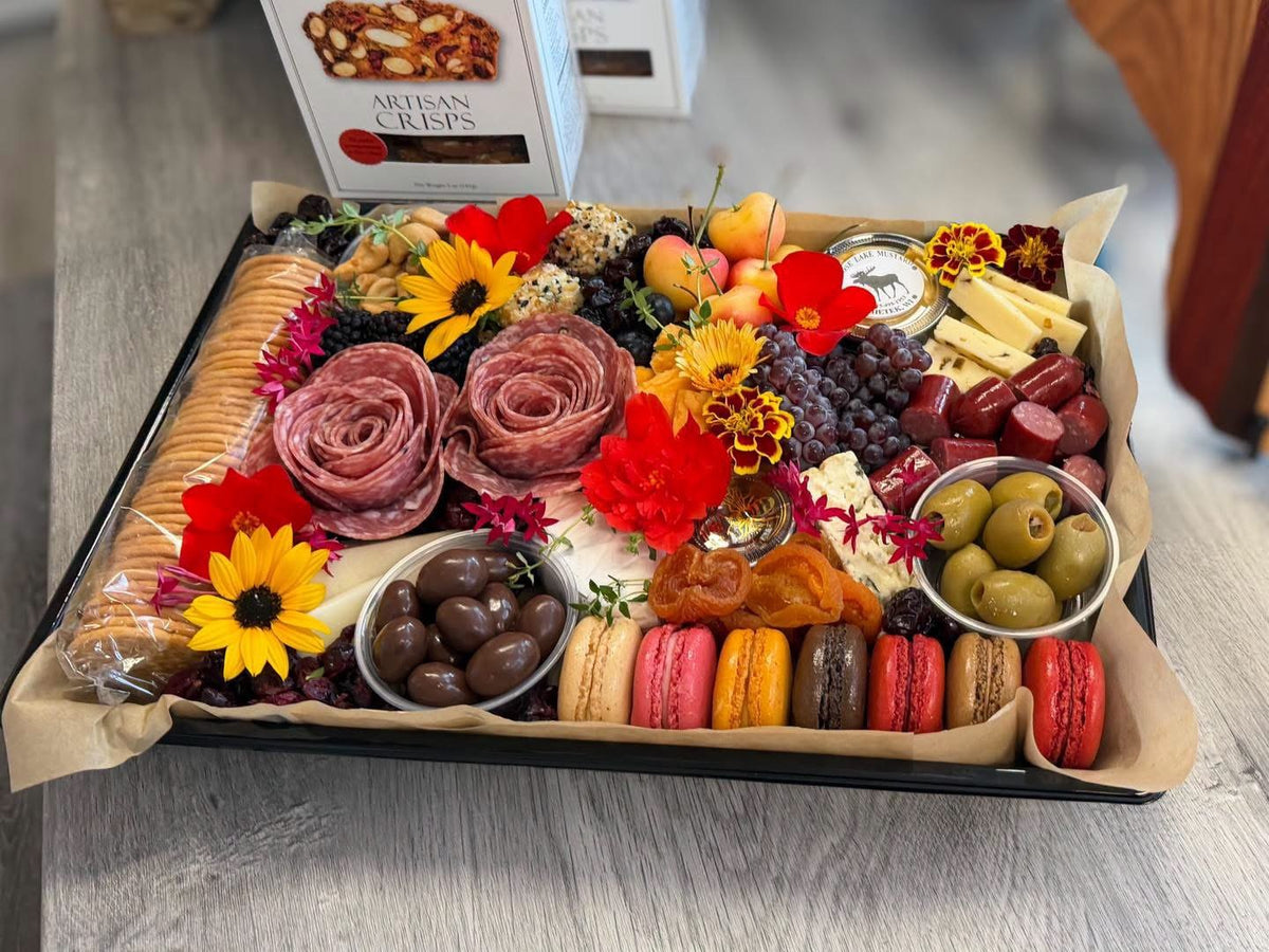 The Gather Board charcuterie platter with artisan crisps, salami roses and Moose Lake Mustard on a shop table