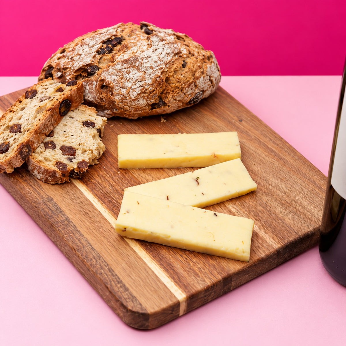 Portabella & Chive mushroom cheese with soda bread and wine on a hot pink background