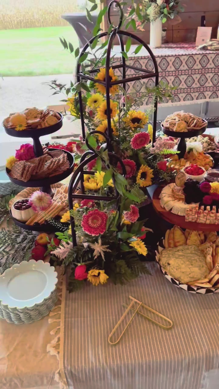 Video of a That Girl Brie grazing table in a barn with sunflowers and dahlias