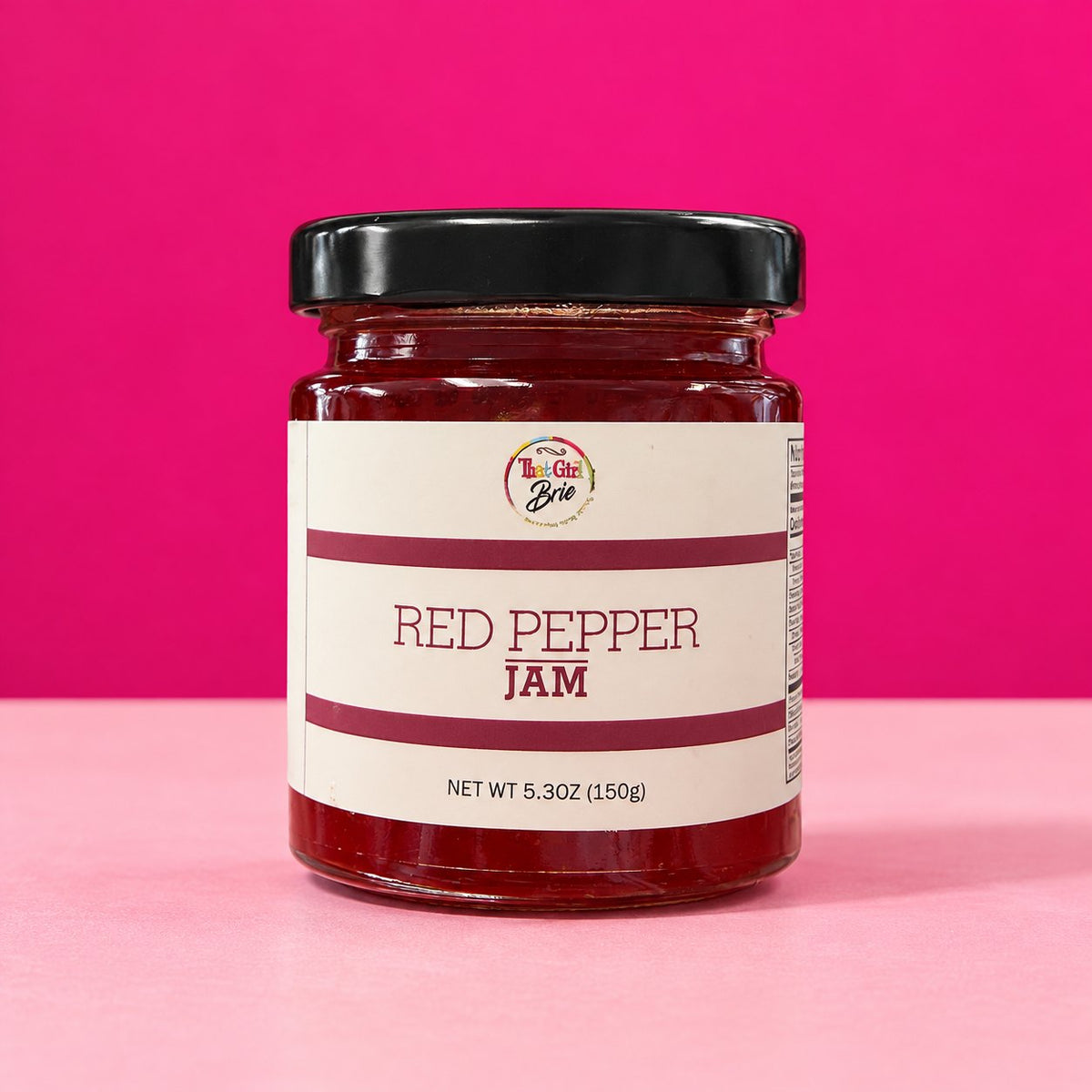 Red Pepper Jelly jar on a hot pink background