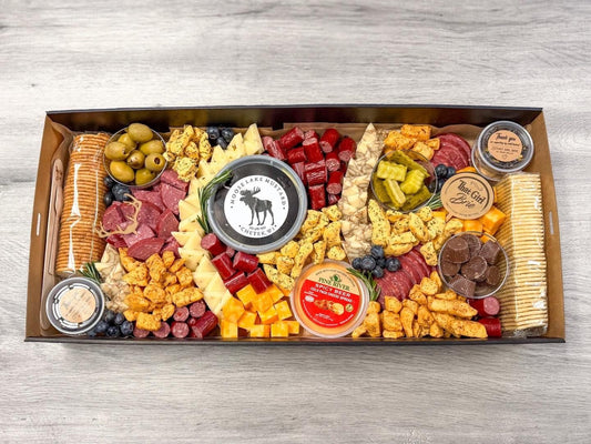 The Northwoods TGB Box, a cabin charcuterie box with sausage, cheese curds, Moose Lake mustard and pickles