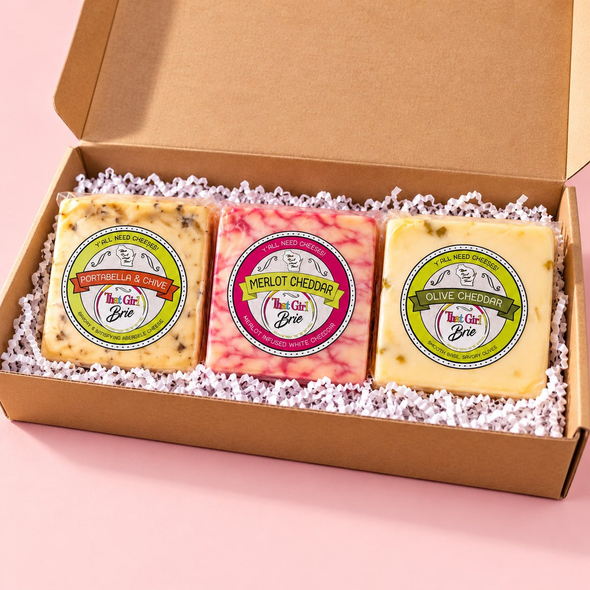 The TGB Trio cheese sampler with Portabella & Chive, Merlot Cheddar and Olive Cheddar in a gift box