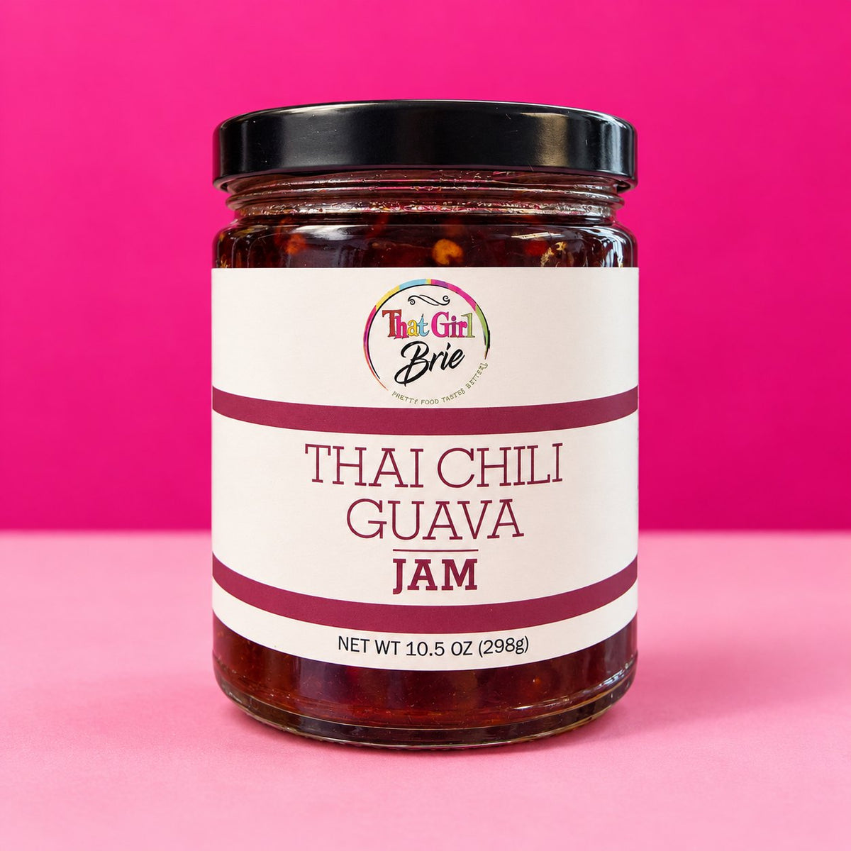 Thai Chili Guava jam jar on a hot pink background