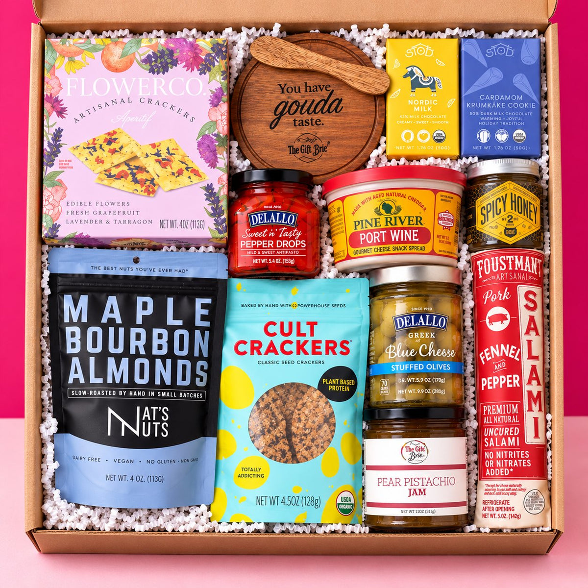 The Whole Shebang shelf-stable meat and cheese gift box on a hot pink background