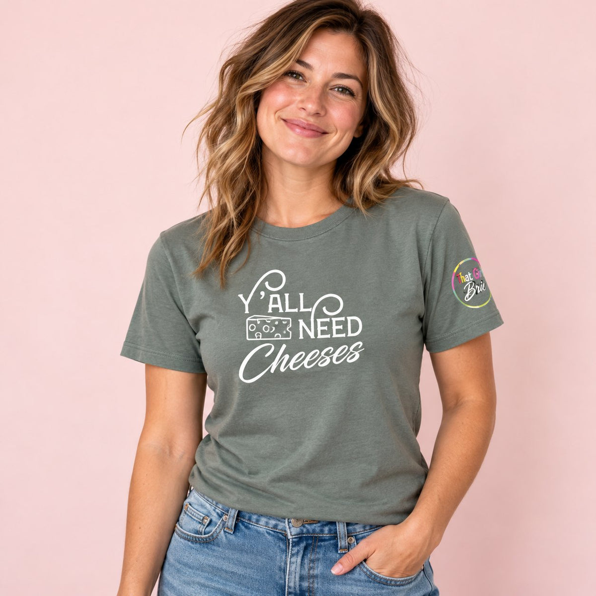 Woman wearing the heather green Y'all Need Cheeses cheese t-shirt
